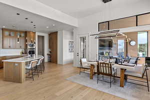 Dining room featuring light wood-style flooring and recessed lighting