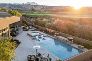 View of pool with an in-ground hot tub, a mountain view, a patio, view of golf course, and outdoor dining area