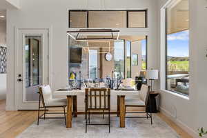 Dining area with wood finished floors and recessed lighting