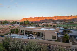 Back of house featuring a mountain view, stucco siding, a patio, and a jacuzzi