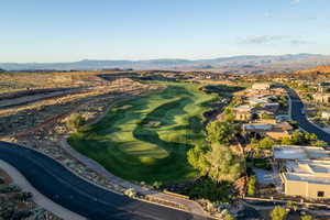 Aerial view of property's location featuring a mountain backdrop and nearby suburban area
