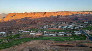 Aerial view of residential area with mountains and a local golf course