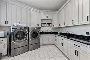 Laundry area featuring cabinet space and washing machine and clothes dryer