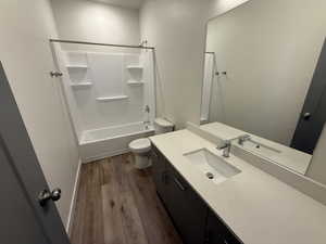 Full bath with vanity, wood finished floors, and bathing tub / shower combination