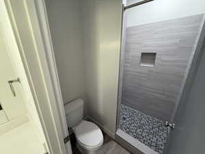 Full bath with a stall shower and toilet