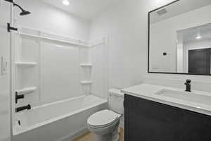 Full bathroom featuring vanity, bathtub / shower combination, and recessed lighting