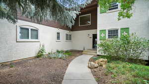 View of exterior entry featuring stucco siding