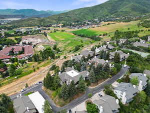 Aerial view of property's location featuring nearby suburban area and a mountainous background