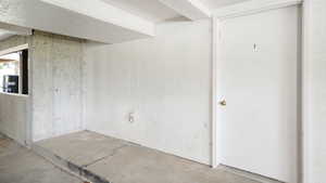 Unfurnished room with unfinished concrete floors