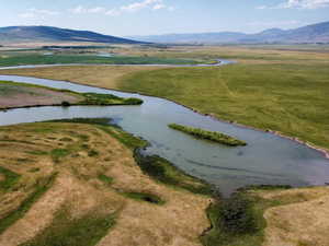 Aerial view of property's location featuring a water and mountain view