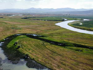 Aerial overview of property's location featuring a water and mountain view and rural landscape