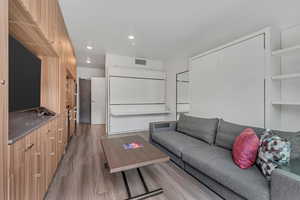 Living room with wood finished floors and recessed lighting