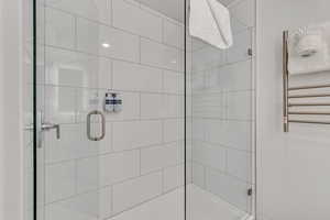 Bathroom with a shower stall and radiator heating unit