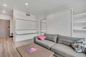 Living area featuring light wood-type flooring and recessed lighting