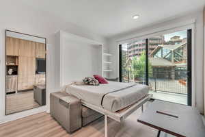 Bedroom featuring light wood-style flooring and access to outside