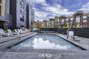 Community pool featuring a residential view and a patio area