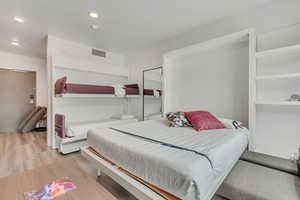 Bedroom with wood finished floors and recessed lighting