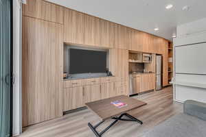 Living room with recessed lighting and light wood finished floors