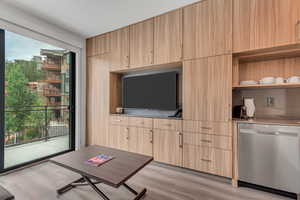 Living area with light wood finished floors and healthy amount of natural light