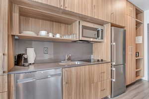 Kitchen featuring open shelves, modern cabinets, and light brown cabinets