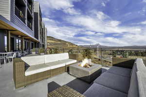 View of patio / terrace featuring a mountain view and an outdoor living space with a fire pit