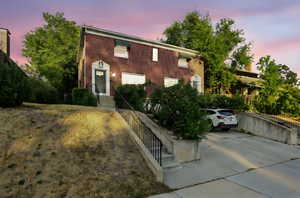 Colonial inspired home featuring brick siding and driveway