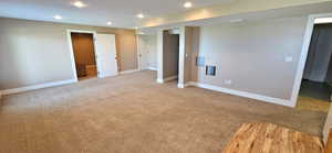 Unfurnished bedroom featuring light carpet and recessed lighting