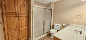 Bathroom featuring a stall shower, vanity, and tile patterned floors
