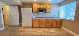 Kitchen with freestanding refrigerator, stainless steel microwave, and recessed lighting