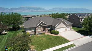 Craftsman-style home featuring stone siding, an attached garage, concrete driveway, and roof with shingles