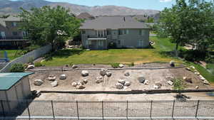 Rear view of property with a mountain view, stucco siding, and a residential view
