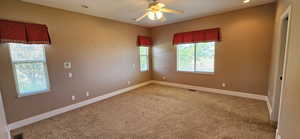 Unfurnished room featuring a ceiling fan, light carpet, and recessed lighting