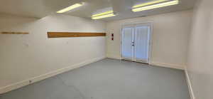 Empty room with concrete floors and baseboards