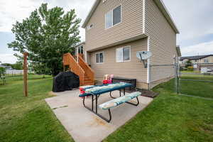 Rear view of house with a patio area, a gate, and stairs