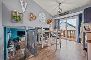 Dining room with wood finished floors and vaulted ceiling