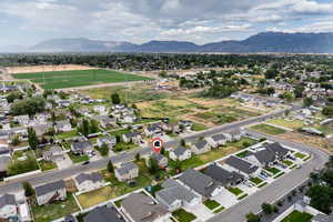 Aerial view of property's location featuring a mountain backdrop and nearby suburban area