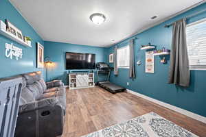 Exercise area featuring wood finished floors and baseboards