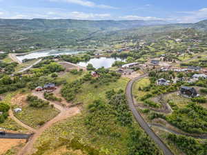 Aerial overview of property's location featuring a water and mountain view
