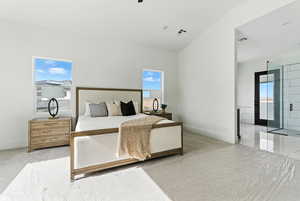 Primary bedroom with multiple windows and high vaulted ceiling