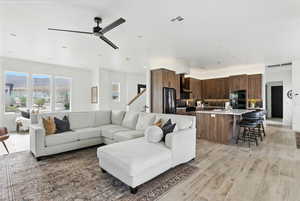 Living area with light wood-type flooring and ceiling fan