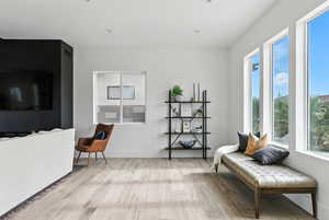 Living room large windows and light wood-style floors