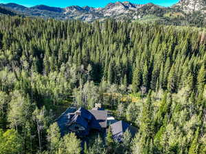 Aerial view of property and surrounding area with a mountain backdrop