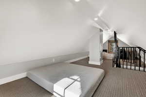 Bedroom featuring carpet flooring, lofted ceiling, and recessed lighting