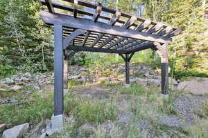 View of home's yard with a pergola