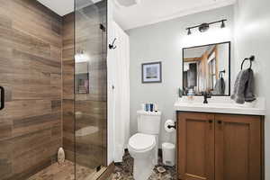 Full bath featuring vanity and a shower stall