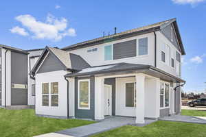 View of front of house with a front lawn and stucco siding