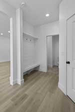 Mudroom with wood finished floors and recessed lighting