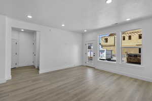 Empty room featuring recessed lighting and light wood-type flooring