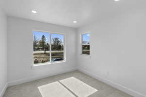 Carpeted spare room with recessed lighting