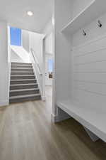 Mudroom with wood finished floors and recessed lighting